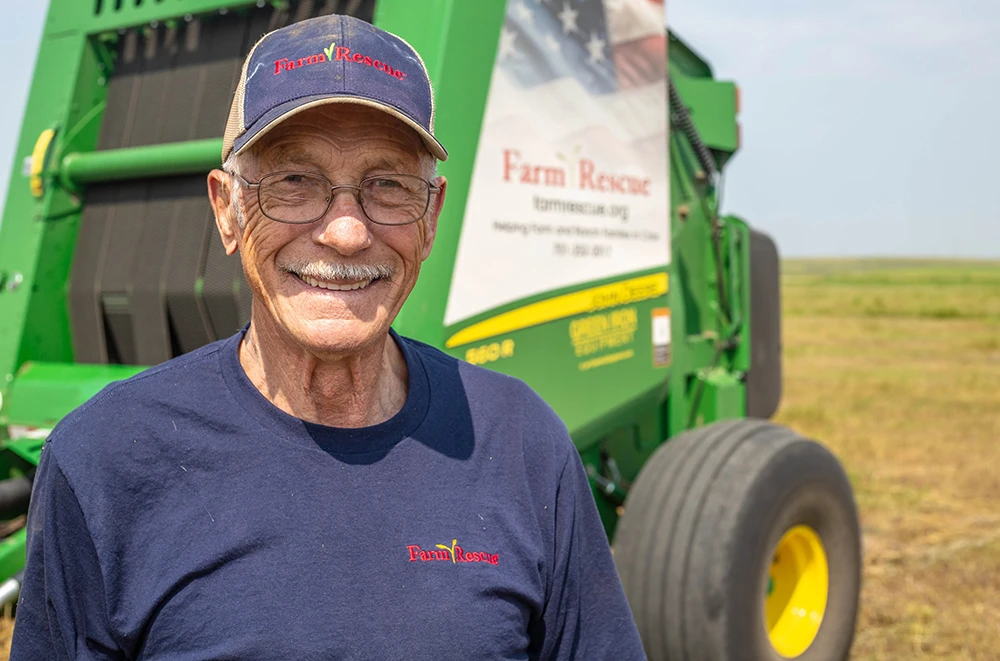 Farmer baling hay