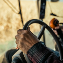 detail of farmer driving tractor